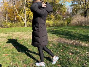 Person wearing the Triple F.A.T. Goose Women's Fara Puffer Down Jacket while walking in grass