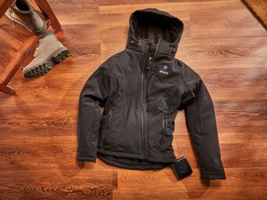 Ororo Women's Classic Heated Jacket laid out on a wood floor
