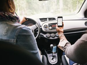 Women using phone to navigate while driving