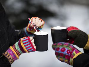 Winter Scene of Hot cocoa and girls hands in mittens