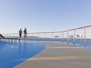 Young couple is jogging around the shipdeck of a cruise ship, Mediterranean Sea