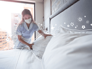 A maid cleaning a hotel room with a mask on. Illustrated icons