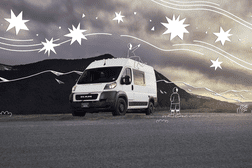A van in a valley with drawn on people and stars